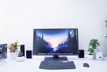 Turned-on Black Flat Screen Computer Monitor and Keyboard