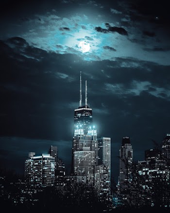 Turned-on Building Lights Under Cloudy Sky