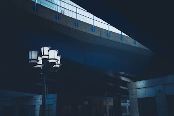 turned on floor lamp beside building
