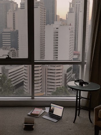 Turned-on Laptop Computer Beside Glass Window
