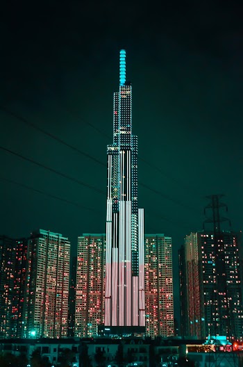 Turned on Light in High Rise Building in Front of Other Buildings at Night