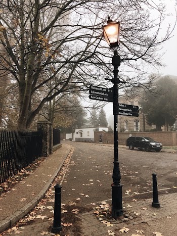 Turned-on Light Post Near Black Fence