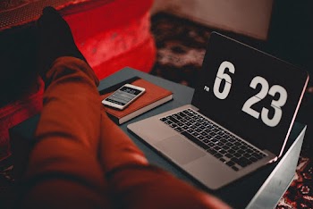 Turned-on Macbook Air Displaying Time at 6:23 Pm