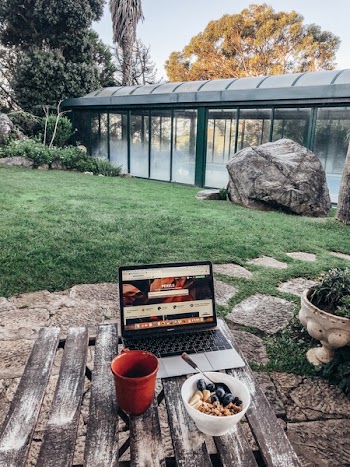 Turned-on Macbook Pro on Brown Table