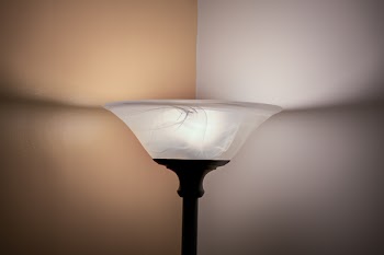 Turned on White and Black Torchiere Lamp