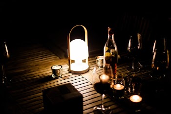 Turned on White Lamp Beside Wine Bottle