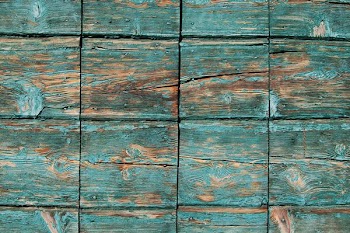 Turquoise paint coming off square wooden planks