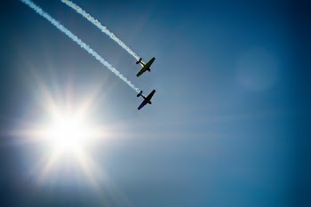 Two Airplane Flying Under Blue Sky Emitting White Smoke