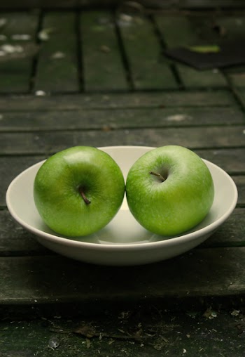 two apples on a white plate