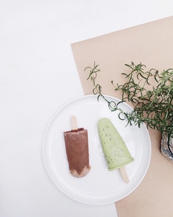 Two Assorted-flavor Ice Pop on Top of White Plate