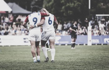Two athletes Standing in a Field