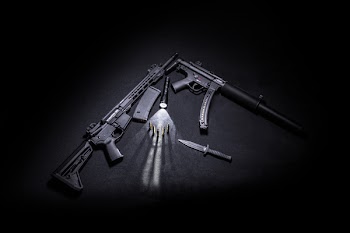 Two Black Assault Rifle Beside Tactical Knife, Bullets, and Torch.