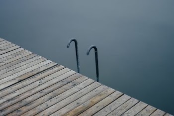 two black metal hooks near wooden dock