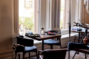 Two Black Plates on Top of Brown Table