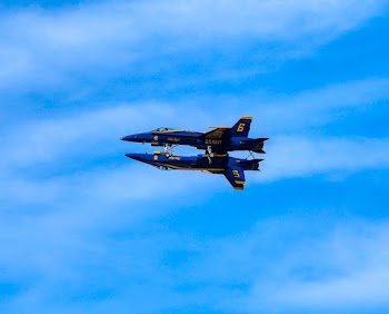Two Blue and Yellow Airplanes on Skies