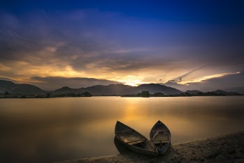 Two Boats Docked On Seashore