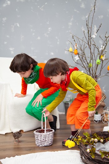Two Boys Beside Basket and Sofa Chair
