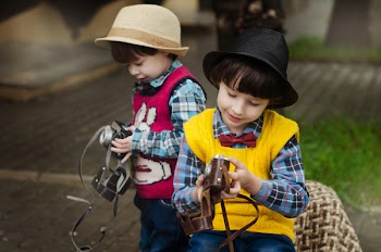Two Boys Holding Camera