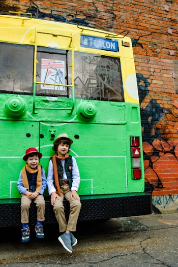 Two Boys Seating on Bus Tailgate