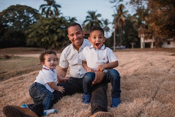Two Boys Sitting On Man's Lap 