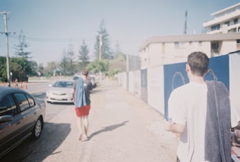 Two Boys Walking Beside Road