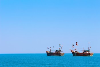 Two Brown Boats on the Middle of Calm Water