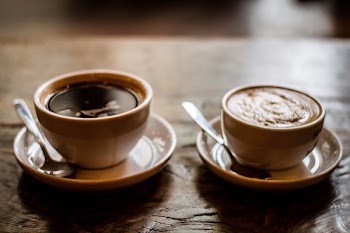 Two Brown Ceramic Teacups With Latte