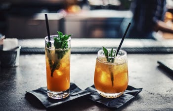 Two Brown Liquid Inside Clear Drinking Glasses