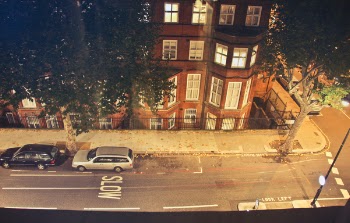 Two Cars Parked Near Brown Concrete Building during Nighttime