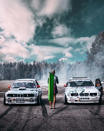 two cars waiting for woman to start their race
