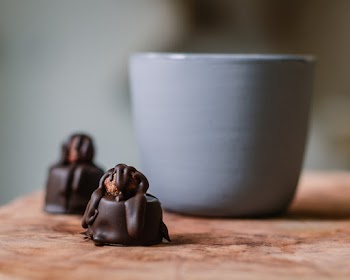 Two Chocolate Bites on Top of Brown Table