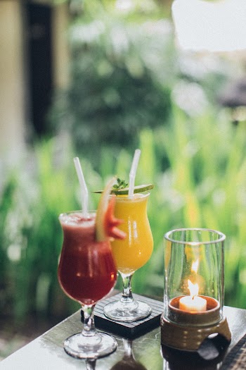 Two Clear Drinking Glasses Filled With Juice Selective Focus Photography