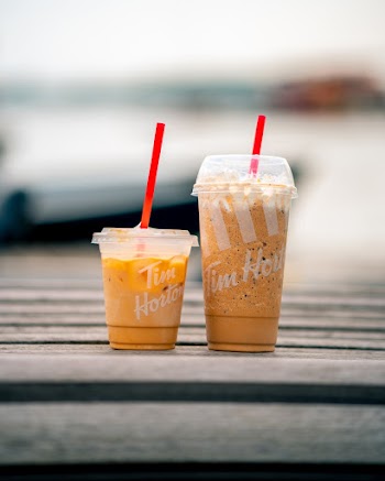 Two Clear Plastic Cups on Gray Surface