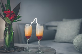 Two Clear Wine Glasses Filled With Red Liquids