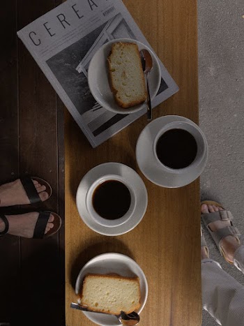 Two Cup of Coffees Between Two Sliced Breads