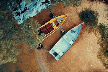 Two Empty Wooden Boats on Sand