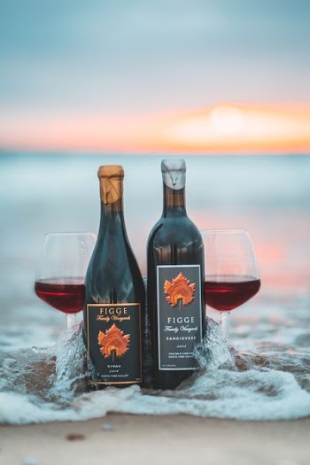 two Figge wine bottles on beach
