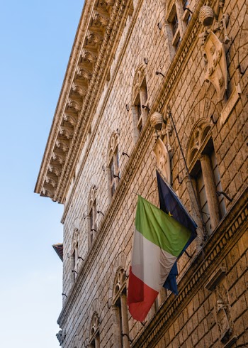 Two Flags Hanging on Building