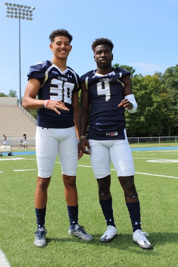 Two Football Players Taking Picture on Football Field