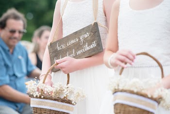 Two Girls Holding Brown Baskets