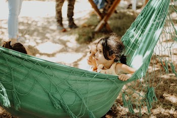Two Girls Sitting on Green Hammock