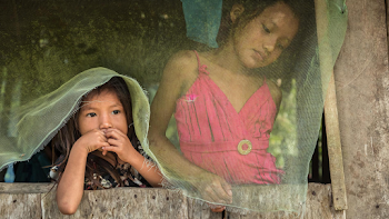 Two Girls Standing in Window