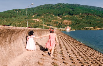 Two Girls Walking Near Body of Water