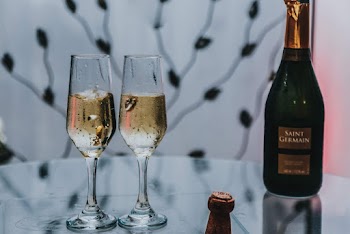Two Glasses of Wines Beside Bottle