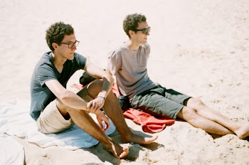 Two Guys Sitting by the Beach