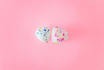 two heart-shaped white balloons