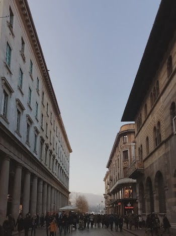 Two High Rise Buildings and People on the Street