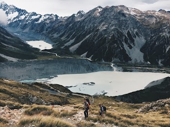 Two Hikers Climbing Up Mountain