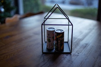 Two Labeled Thin Cans on Black Frame