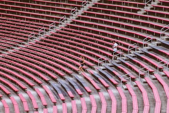 two man and woman jogging on stadium bench